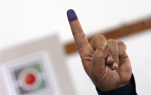 A Palestinian police officer shows his ink-stained finger after casting an early vote during local elections at a polling station in the West Bank town of Jenin, Thursday, Oct. 18, 2012. Members of Palestinian security forces cast an early vote ahead of local elections which are to take place across the West Bank on October 20, 2012, in the first such polls since 2006. (AP Photo/Mohammed Ballas)